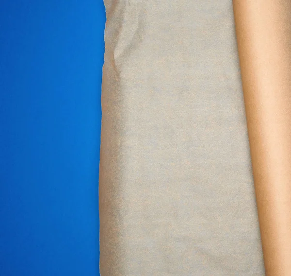 roll of brown parchment paper on a blue background