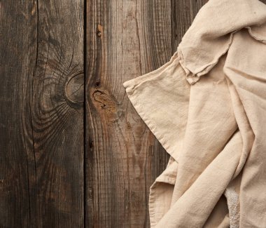 Gri mutfak tekstil havlusu eski tahtalardan, üst manzaradan, boş alandan gri ahşap bir masaya katlanmış. Kırsal doku. Retro arkaplan