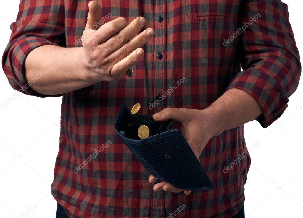 man in a red shirt pours hryvnia coins from a brown leather wallet into his hand, poverty concept
