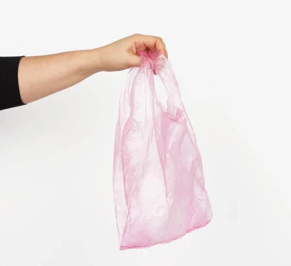 Handen Håller Tom Rosa Plastpåse Vit Bakgrund Begreppet Avvisande Plast — Stockfoto