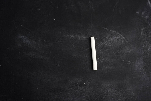 empty black chalk board and white chalk sticks, place for inscription