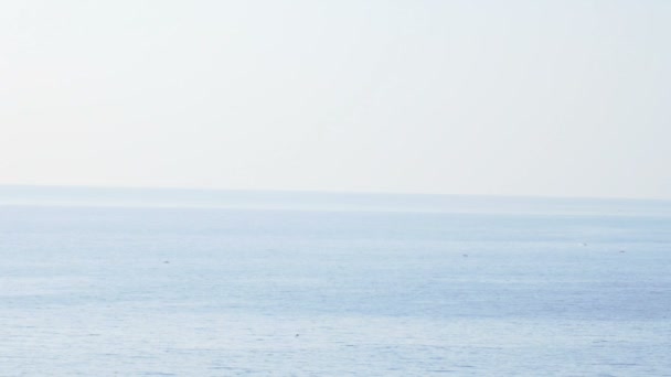 Following the sea and a lighthouse near the sea, blue calm sea — Αρχείο Βίντεο