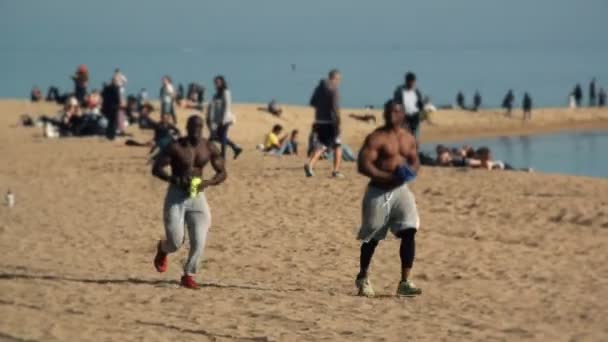 Blurred shot of fit and exhausted runners passing by the beach in Barcelona