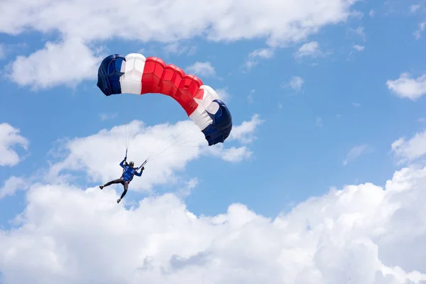 Paraplane in blue cloudy sky Royalty Free Stock Photos