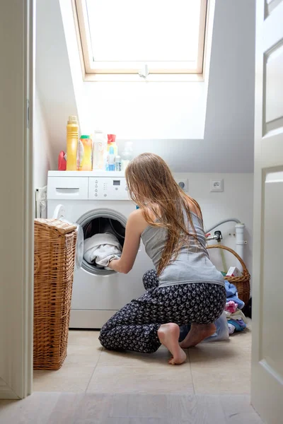 Woman puting clothes into washing maschine — Stock Photo, Image
