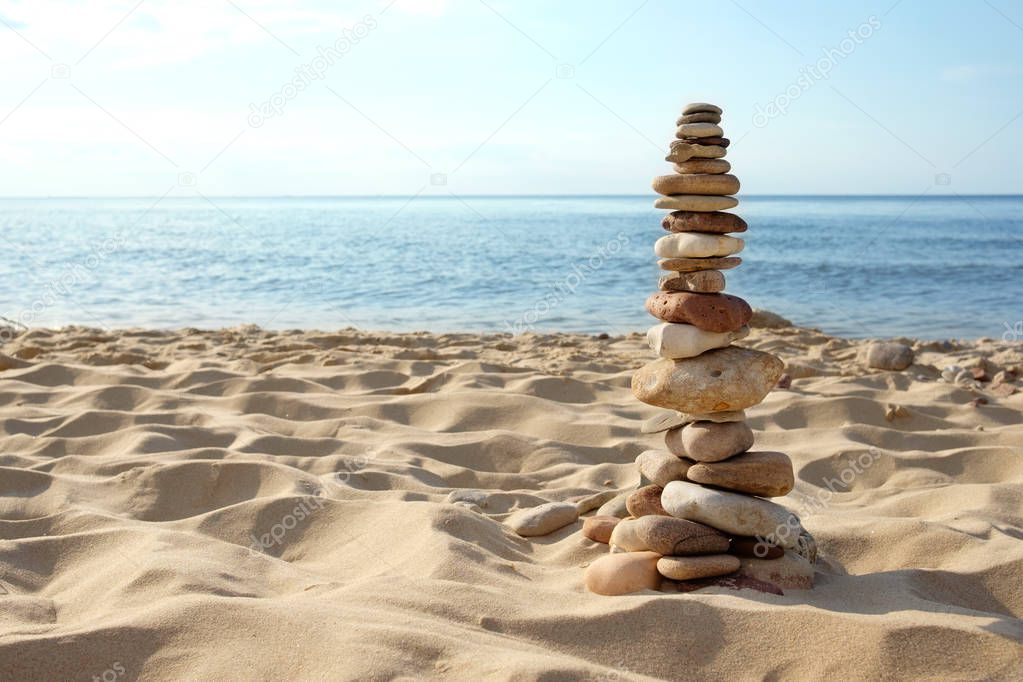 tower of rocks on beach