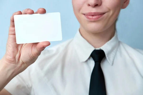 Closeup view of employee of the bank offers a plastic card. Business woman showing plastic credit card or business card.