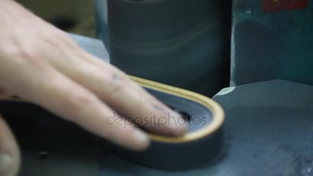 A close-up shoemaker gives the shape of a soles of shoes — Stock Video