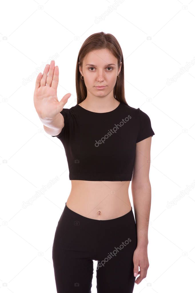 Serious young woman showing stop gesture, isolated over white background