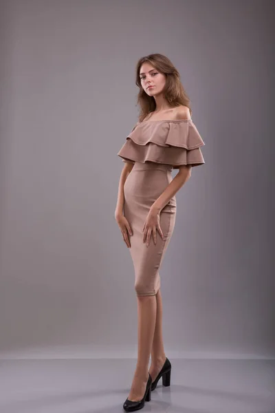 Atractivo dijo mujer posando en vestido ligero sobre fondo gris —  Fotos de Stock
