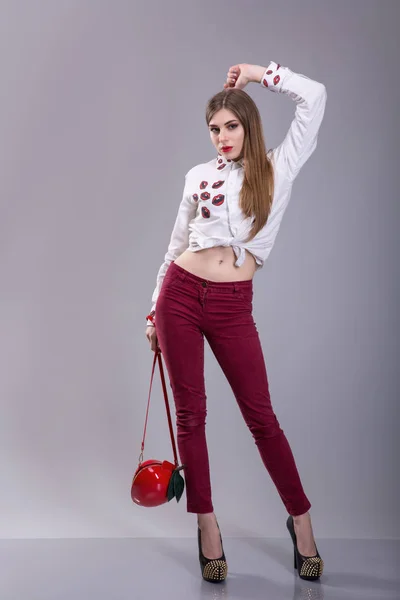 Hermosa mujer morena sexy usar pantalones rojos y falda whie. ropa de colección de verano, bolsa de mercancías hacer una pose modelo catálogo de moda . —  Fotos de Stock