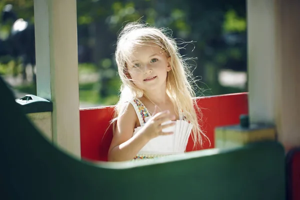 Verão, infância, lazer, gesto e conceito de pessoas - menina feliz brincando no parque infantil — Fotografia de Stock