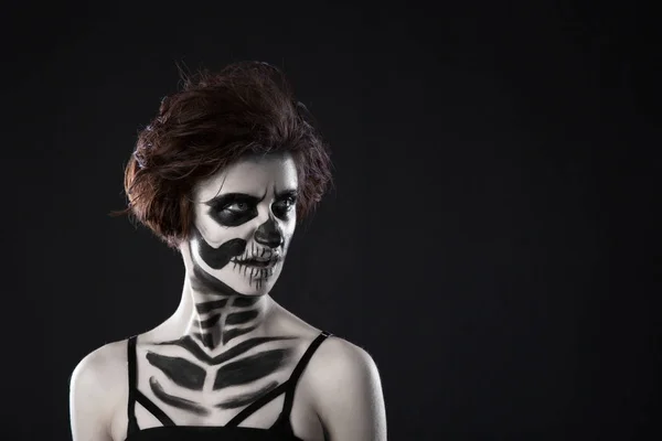 Portrait of young woman with scared halloween makeup on black background — Stock Photo, Image