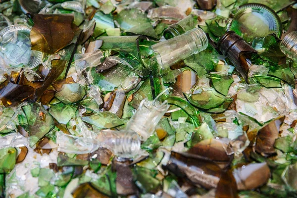 Shards of glass bottles green, scattered on the white surface.