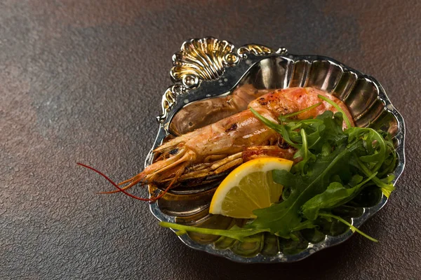 Un camarón tigre frito o langostino con verduras y limón en un plato antiguo —  Fotos de Stock