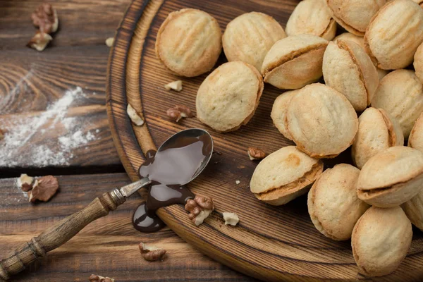 Zelfgemaakte koekjes vormige noten met gekookte gecondenseerde melk op houten tafel. Rustieke stijl — Stockfoto