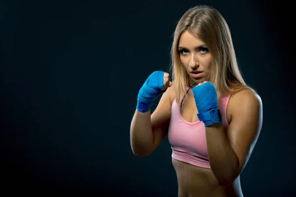fitness woman with the blue boxing bandages, studio shot