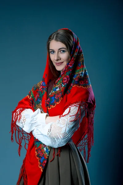 Russian beauty woman in the national patterned shawl on blue grey background. Maslenitsa — Stock Photo, Image