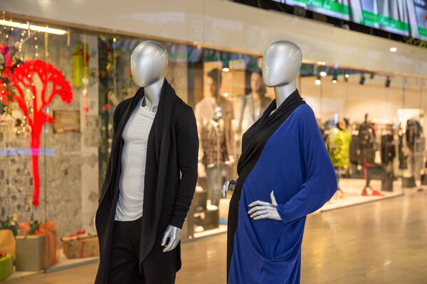 mannequins standing in the shop window Display casual woman and man clothing store in the Mall