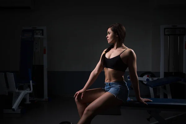 Retrato de hermosa mujer deportiva sentada en el gimnasio —  Fotos de Stock