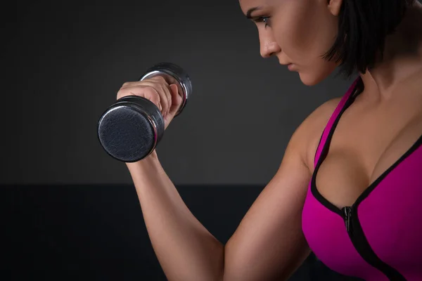 Fitness modeli esmer siyah arka plan üzerine ağırlık tutarak — Stok fotoğraf