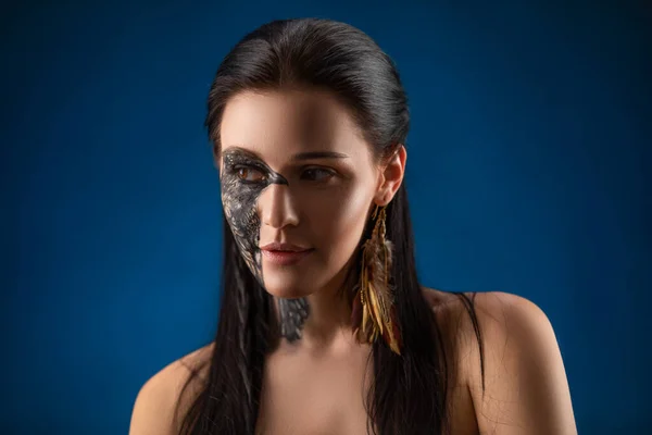 Portrait of young sensual brunette woman with black raven bird body art on her face. — Stock Photo, Image