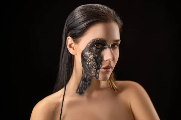 Portrait of young sensual brunette woman with black raven bird body art on her face. — Stock Photo, Image