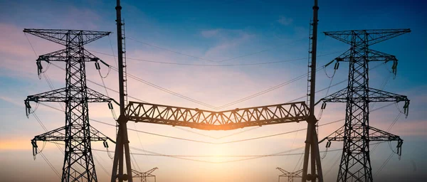 Impression network at transformer station in sunrise, high voltage up to yellow sky take with yellow tone, horizontal frame