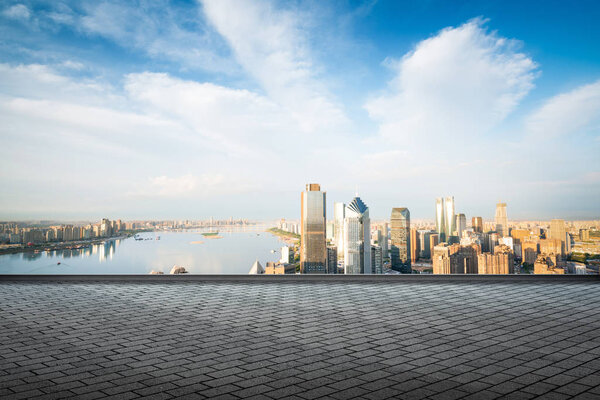 Empty marble floor with cityscape and skyline in cloud sky