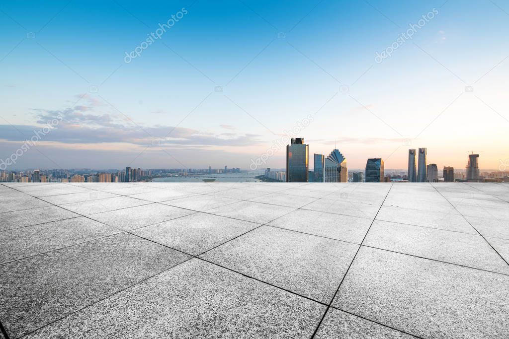 cityscape and skyline of hangzhou from empty brick floor