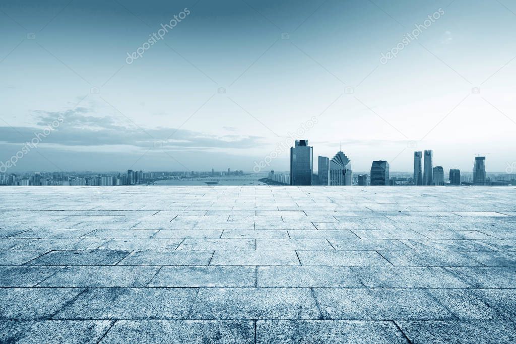 cityscape and skyline of hangzhou from empty brick floor