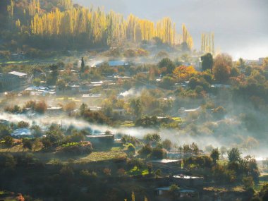 Altit Village In Mist And Hunza Valley In Autumn, Karimabad, Pakistan clipart