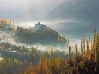 Altit Fort With Surrounding Mist And Hunza Valley In Autumn, Karimabad, Pakistan clipart
