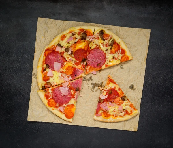 Pieczone plasterki pizzy na ciemnym tle — Zdjęcie stockowe