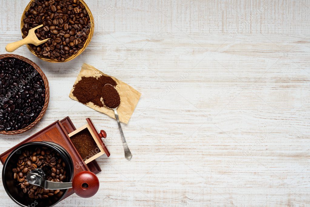 Dark and Brown Coffee Beans with Grinder on Copy Space