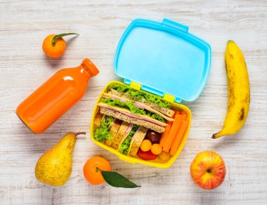 Lunch Box with Drinks, Sandwiches and Fruits clipart