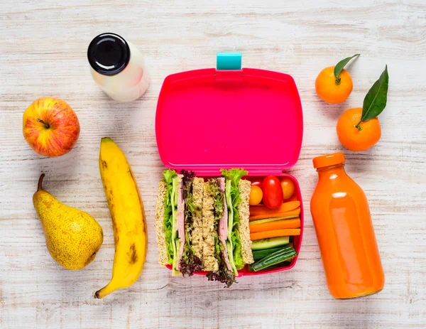 Pink Lunch Box with Tasty looking Fruits and Vegetables