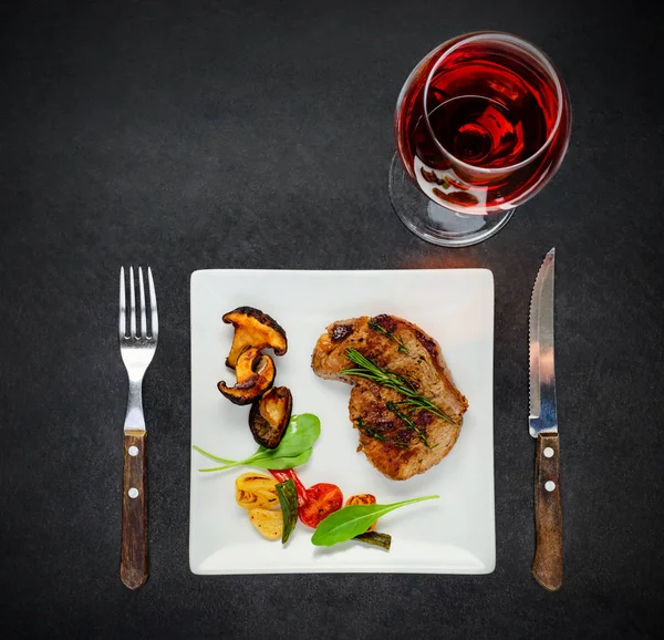 Placa con filete, champiñones y copa de vino — Foto de Stock