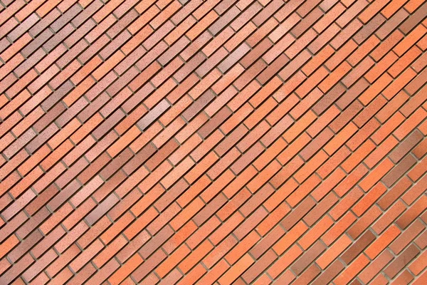 Red brick wall, background, diagonal position, stone texture. — Stock Photo, Image