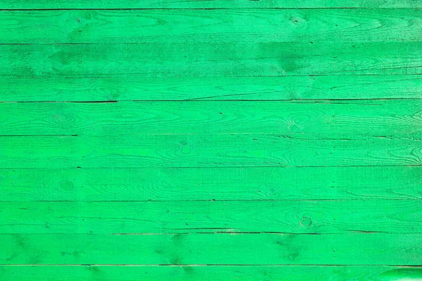 Light green painted wooden fence made of pine boards, green wall background, pine wood texture — Stock Photo, Image