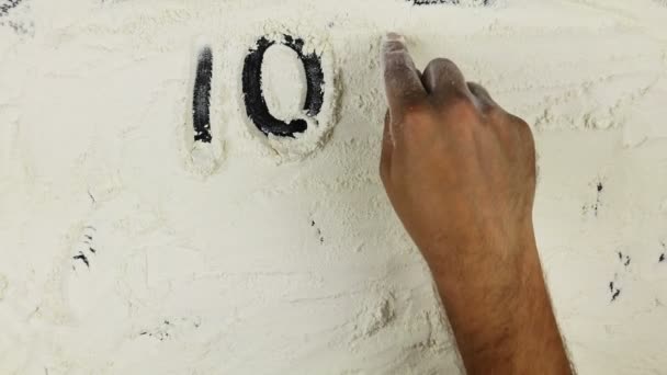 Young man writes a word 100 natural on white flour — ストック動画