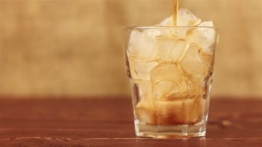 Buzlu Cola. Bir ahşap masa ve kahverengi arka cam buz ve kabarcıklar Cola dökme