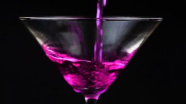 Martini cam siyah zemin üzerine kırmızı kokteyl dökme