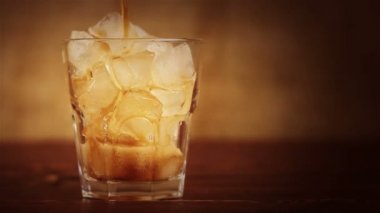 Buzlu Cola. Bir ahşap masa ve kahverengi arka cam buz ve kabarcıklar Cola dökme