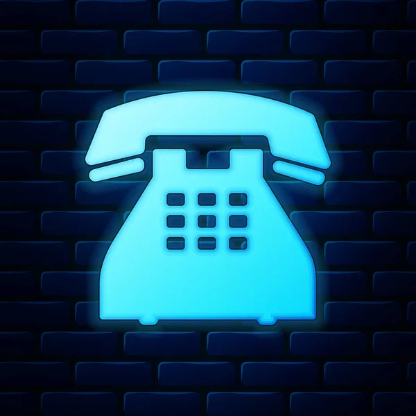 Glowing neon Telephone icon isolated on brick wall background. Landline phone. Vector Illustration — Stock Vector