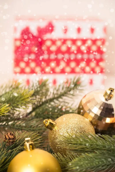 Christmas decoration set in red basket on white wooden desk. Bright and joyful new year.