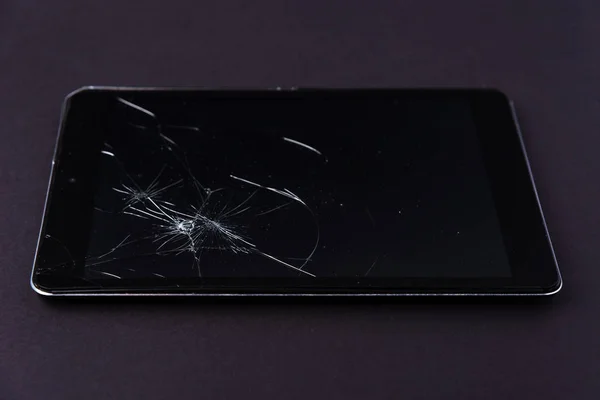 Image with broken display of a smartphone or tablet computer on black background.
