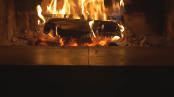Warm cozy fire in a Home Fireplace. Real wood Burning in a Brick Fireplace tilt up — Stock Video