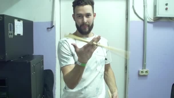 Drummer man demonstrates mastery of the drumsticks, warm up before a musical performance, slow motion — Stock Video