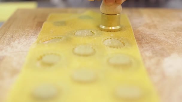 Mens hands of the chef cut ravioli from the dough with a figured round knife, close-up, slow motion — Stock Video